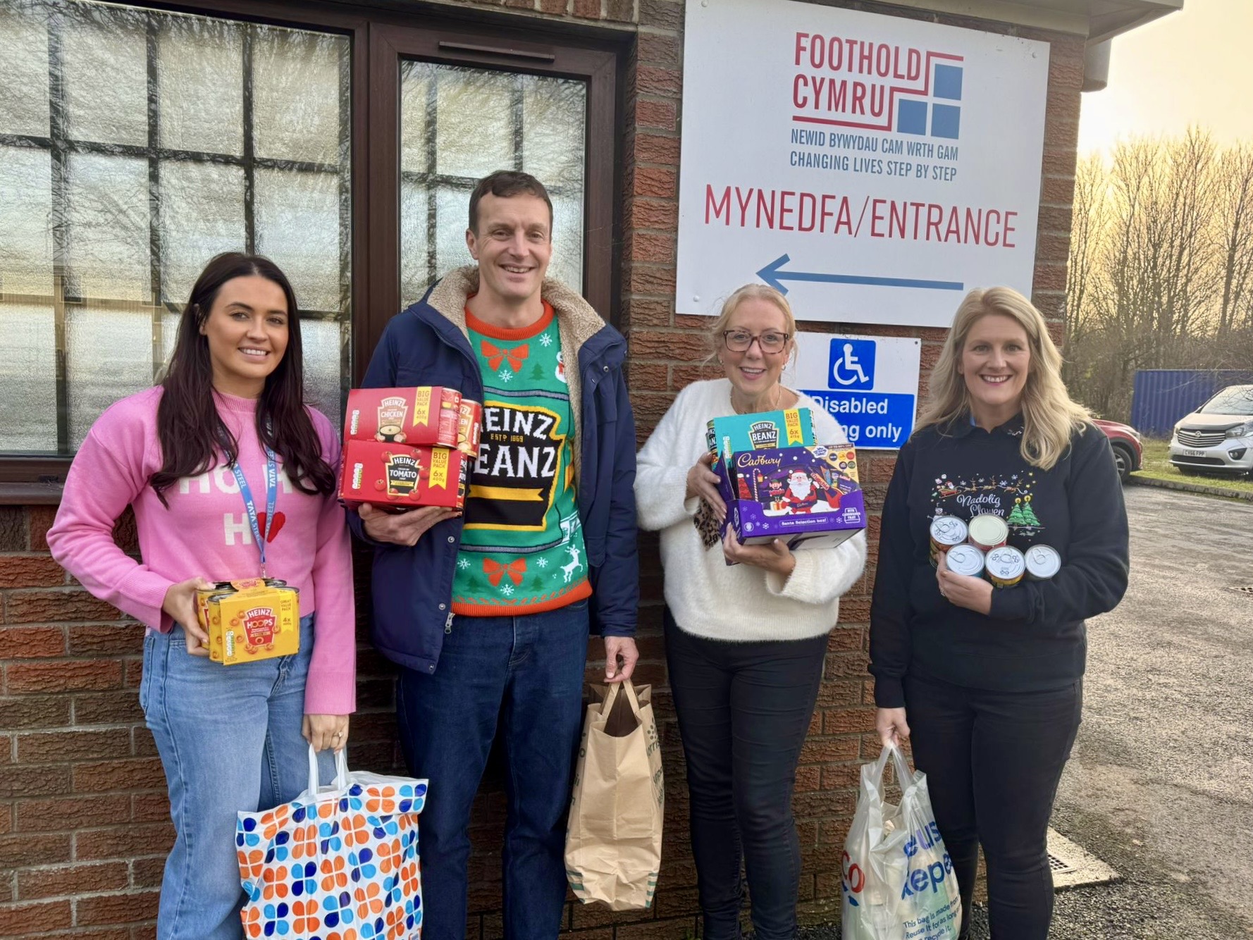 Trostre staff drop off food at Foothold Cymru food bank
