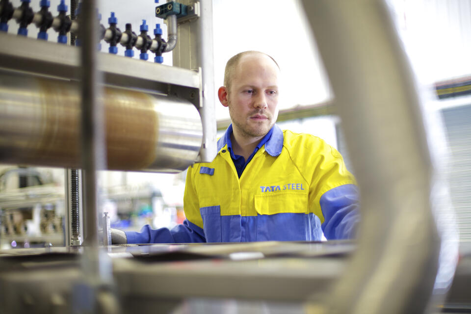 Steel worker working with machinery