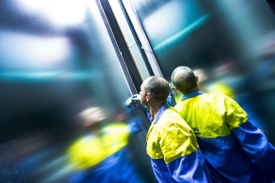 Tata Steel employee in high viz jacket checking steel Tata Steel employee in high viz jacket checking steel