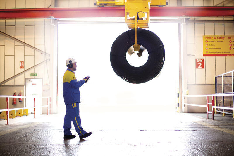 Tata Steel worker using a hand held remote device to move a coil at Dudley service centre