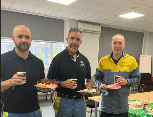 Steelworkers enjoying coffee and cake in aid of MacMillan